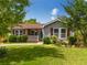Well-maintained single-story home with lush green lawn, mature trees, and charming curb appeal at 445 Brownell Ave, Scottdale, GA 30079