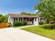 Inviting single-story home with beautiful landscaping and a quaint front porch at 445 Brownell Ave, Scottdale, GA 30079