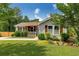 Charming single-story home with a well-manicured front yard, featuring lush green grass and mature trees at 445 Brownell Ave, Scottdale, GA 30079