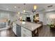 Contemporary kitchen with granite island, stainless steel appliances, and an open view into the living area at 445 Brownell Ave, Scottdale, GA 30079