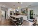 Modern kitchen with white cabinetry, granite countertops, stainless steel appliances, and a floral island at 445 Brownell Ave, Scottdale, GA 30079