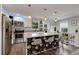 Stylish kitchen featuring a floral-patterned island, white cabinetry, stainless steel appliances, and modern lighting at 445 Brownell Ave, Scottdale, GA 30079