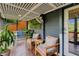 Relaxing screened-in porch offering outdoor living space with comfortable chairs and a fan at 445 Brownell Ave, Scottdale, GA 30079