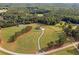 Expansive aerial view of a sprawling estate with a winding driveway and lush surrounding landscape at 829 Christopher Rd, Sharpsburg, GA 30277
