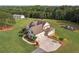 Aerial view of home featuring a large driveway, metal outbuilding, playground, and beautifully maintained grounds at 829 Christopher Rd, Sharpsburg, GA 30277
