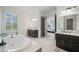 Luxurious bathroom with double vanities, a soaking tub, and a separate shower at 829 Christopher Rd, Sharpsburg, GA 30277