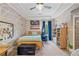 Fun bedroom with lots of decor, maps on the wall, and a ceiling fan at 829 Christopher Rd, Sharpsburg, GA 30277