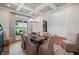 Traditional dining room with decorative wallpaper, paneled walls, and a large window at 829 Christopher Rd, Sharpsburg, GA 30277