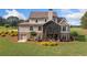 Rear view of the home with screened porch, walkout basement, lush lawn, and mature landscaping at 829 Christopher Rd, Sharpsburg, GA 30277