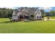 Beautiful two-story home featuring stone accents, manicured landscaping, and a well-maintained lawn at 829 Christopher Rd, Sharpsburg, GA 30277