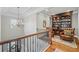 Lovely upstairs foyer with a library and a beautiful chandelier at 829 Christopher Rd, Sharpsburg, GA 30277