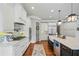 Gourmet kitchen featuring white cabinets, stainless steel appliances, and expansive island at 829 Christopher Rd, Sharpsburg, GA 30277