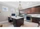 Well-appointed laundry room with stainless steel appliances, custom desk and cabinets, and a modern light fixture at 829 Christopher Rd, Sharpsburg, GA 30277