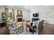 Cozy living room features shiplap walls, brick fireplace, and patterned armchairs at 829 Christopher Rd, Sharpsburg, GA 30277