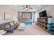 Cozy living room with lots of storage, a grey couch, a ceiling fan, and grey walls at 829 Christopher Rd, Sharpsburg, GA 30277