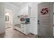 Inviting mudroom featuring custom built-in storage, seating, and convenient access to the front door and powder room at 829 Christopher Rd, Sharpsburg, GA 30277