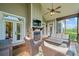 Covered porch with stone fireplace, comfortable seating, and views of the backyard at 829 Christopher Rd, Sharpsburg, GA 30277