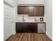 Compact wet bar with dark wood cabinets, marble backsplash, and stainless steel mini-fridge at 829 Christopher Rd, Sharpsburg, GA 30277