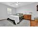Comfortable bedroom featuring hardwood floors, neutral walls, and classic furnishings at 1650 Tomahawk Trl, Cumming, GA 30041