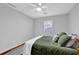 Inviting bedroom with ceiling fan, natural light, and cozy bedding for ultimate relaxation at 1650 Tomahawk Trl, Cumming, GA 30041