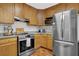 Contemporary kitchen with stainless steel appliances, granite counters, and updated cabinetry at 1650 Tomahawk Trl, Cumming, GA 30041