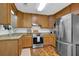 Modern kitchen featuring stainless steel appliances, granite countertops, and stylish wood cabinets at 1650 Tomahawk Trl, Cumming, GA 30041
