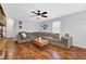Inviting living room with a large sectional sofa, hardwood floors, and natural light at 1650 Tomahawk Trl, Cumming, GA 30041