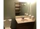 Bathroom featuring a corner sink vanity, large mirror, and shelving, next to the toilet at 286 Toweridge Sw Dr # 3, Marietta, GA 30064