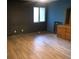 Bedroom featuring wood-look floors, a dark accent wall, and a small window at 286 Toweridge Sw Dr # 3, Marietta, GA 30064