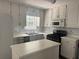 Bright kitchen with white cabinets, modern appliances, and ample counter space at 421 Old Ivy Path, Mcdonough, GA 30253
