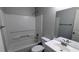 Bathroom features a shower over tub, white toilet, vanity and mirror at 4827 Wyndam Dr, Stone Mountain, GA 30088