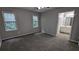 Bedroom features gray walls, gray carpet, ceiling fan and attached bathroom with white vanity at 4827 Wyndam Dr, Stone Mountain, GA 30088