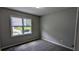 Bedroom features gray walls, gray carpet and a window overlooking the front yard at 4827 Wyndam Dr, Stone Mountain, GA 30088