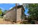 Exterior view of the house showing the side and back with a patio and partial view of the yard at 4827 Wyndam Dr, Stone Mountain, GA 30088