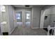 Hallway with gray walls, gray carpet, and several doorways leading to bedrooms and a bathroom at 4827 Wyndam Dr, Stone Mountain, GA 30088