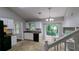 Well-lit kitchen featuring tan tile flooring, white cabinets, and a window overlooking lush greenery at 4827 Wyndam Dr, Stone Mountain, GA 30088