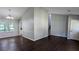 Bright living room with dark wood floors, large windows, and a staircase leading to the upper level at 4827 Wyndam Dr, Stone Mountain, GA 30088