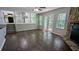 Open living room with a fireplace, wood floors, a view of the kitchen, and access to the backyard at 4827 Wyndam Dr, Stone Mountain, GA 30088