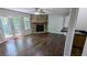 Cozy living room with a stone fireplace, wood floors, ceiling fan, and French doors to the outside at 4827 Wyndam Dr, Stone Mountain, GA 30088