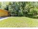 Expansive backyard with a lush green lawn and mature trees, offering privacy at 5509 Covent Way, Lithonia, GA 30058