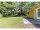 Backyard with patio area and green grass surrounded by trees at 5509 Covent Way, Lithonia, GA 30058