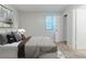 A cozy bedroom features neutral walls and carpet and light-blocking blinds for a relaxing retreat at 5509 Covent Way, Lithonia, GA 30058