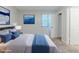 Staged bedroom features a large window and neutral colors at 5509 Covent Way, Lithonia, GA 30058