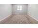 Cozy bedroom featuring plush carpet, neutral walls, and a window offering natural light at 5509 Covent Way, Lithonia, GA 30058