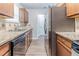 Modern kitchen featuring stainless steel appliances, granite countertops, and wood cabinetry at 5509 Covent Way, Lithonia, GA 30058