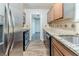 Modern kitchen with stainless steel appliances, granite countertops, and ample cabinet space at 5509 Covent Way, Lithonia, GA 30058