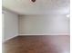 Spacious living room featuring hardwood floors and neutral walls at 5509 Covent Way, Lithonia, GA 30058