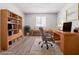 Home office showcasing built-in bookshelves, a large desk, and soft, neutral carpeting at 5509 Covent Way, Lithonia, GA 30058