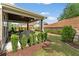 Lush backyard featuring a patio, retaining wall, and manicured lawn at 1972 Clovercroft Rd, Acworth, GA 30101