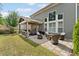 Landscaped backyard with a patio, firepit, and lush green lawn at 1972 Clovercroft Rd, Acworth, GA 30101